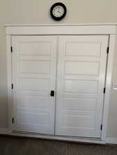 Double doors to furnace, humidifier, and water heater, garage.