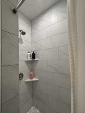 Full bathroom featuring a 9' tile shower.