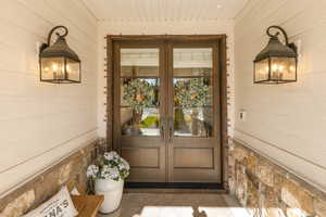 Doorway to property with french doors and a sunroom.