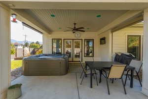 View of patio / terrace featuring ceiling fan, a hot tub, area for grilling, outdoor dining space.