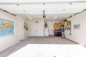 Wide Garage with carpet!!!  Underneath is epoxy brown sealant, with garage door opener.