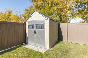 View of shed with a fenced backyard.