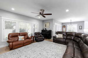 Living area featuring wood finished floors, recessed lighting, and a ceiling fan.