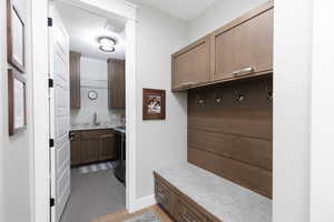 Mudroom with light tile patterned floors and a textured ceiling.