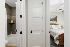 Bathroom with ensuite bath, shower / tub combo with curtain, and a ceiling fan