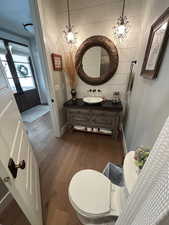 Bathroom featuring light wood-type flooring, vanity, a chandelier, and french doors