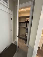 3rd bedroom closet with high ceiling and shelves.
