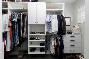View of closet with built in drawers and lots of space.