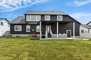 Rear view of property featuring a patio, stucco siding, and roof with shingles