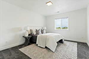Bedroom featuring baseboards and carpet