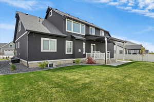 Rear view of house with a patio, roof with shingles, and stucco siding