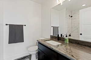 Bathroom featuring vanity and a shower
