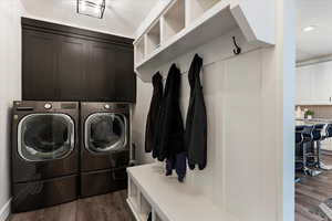 Laundry area featuring dark wood-style flooring and independent washer and dryer