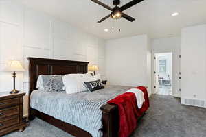 Bedroom with dark colored carpet, recessed lighting, and a ceiling fan