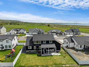 Aerial perspective of suburban area featuring a nearby body of water and a notable bridge