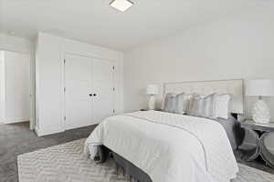 Bedroom featuring carpet flooring and a closet