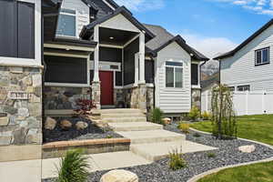 View of front of property with stone siding and a porch