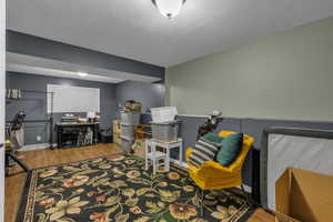 Office area with wood finished floors and a textured ceiling