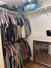 Walk in closet featuring dark wood-style floors