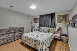 Bedroom with wood finished floors