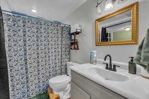 Full bathroom with vanity and curtained shower