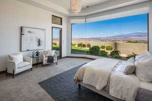 Bedroom with carpet and access to outside