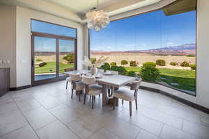 Dining space featuring a chandelier and light tile patterned flooring