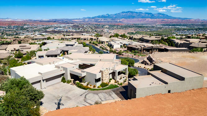 Aerial view of residential area featuring a mountainous background