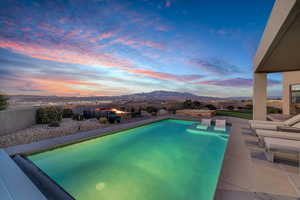 View of pool with a fenced backyard, a patio, and a mountain view