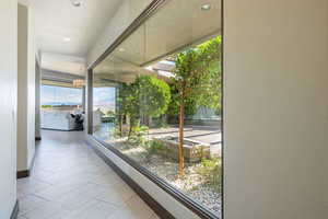 Hall with recessed lighting and light tile patterned floors