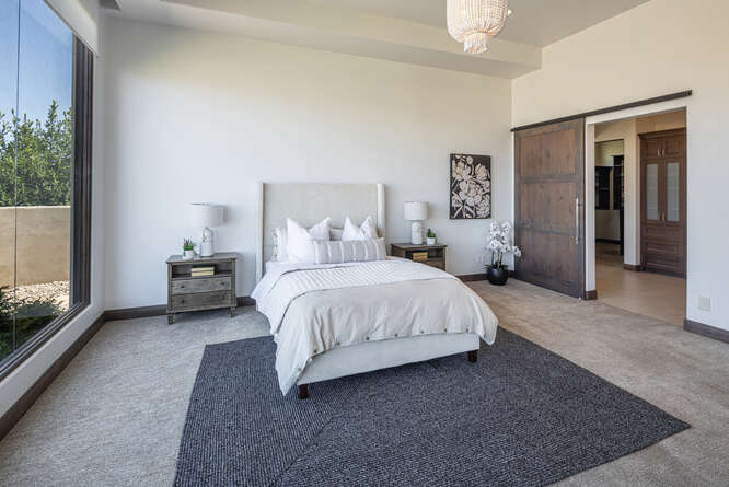 Carpeted bedroom featuring baseboards