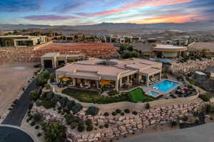 Aerial view at dusk of view of pool and a mountain view