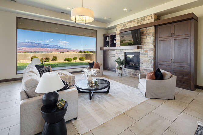 Living area with a stone fireplace and light tile patterned floors