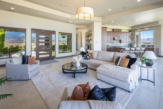 Living room with recessed lighting, a raised ceiling, and tile patterned floors