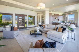 Living room with recessed lighting, a raised ceiling, and tile patterned floors