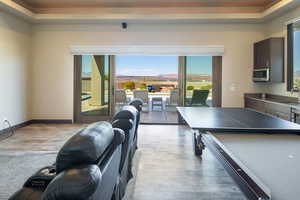 Playroom featuring light wood finished floors and a tray ceiling