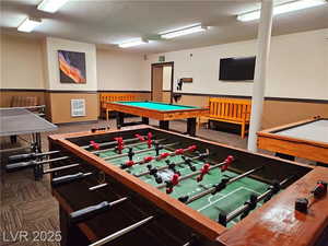 Recreation room with a textured ceiling and billiards