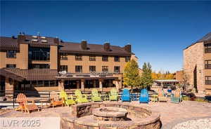 View of patio with an outdoor fire pit