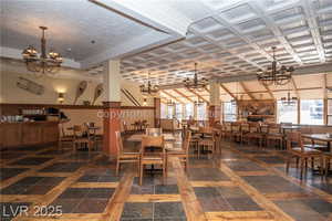 Dining room featuring a chandelier and inlaid floor details