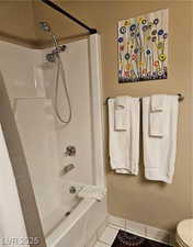 Full bathroom with tile patterned floors and shower / bathtub combination with curtain