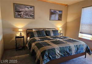 Bedroom featuring carpet flooring and a textured wall