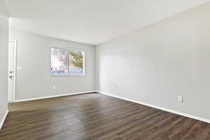 Unfurnished room with dark wood finished floors