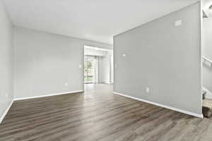 Spare room with stairs and wood finished floors