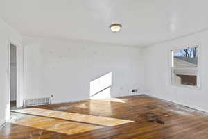 Empty room featuring hardwood / wood-style flooring