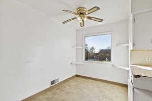 Unfurnished dining area featuring light floors and a ceiling fan