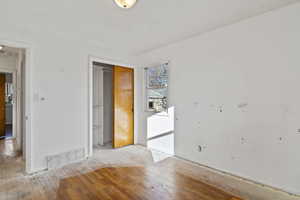 Unfurnished bedroom featuring wood-type flooring and a closet