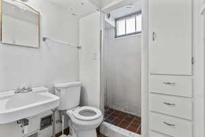 Full bath featuring a shower stall and tile patterned flooring