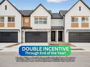 View of front facade with roof with shingles, a standing seam roof, driveway, a metal roof, and stone siding