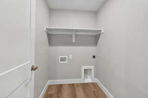 Washroom featuring wood finished floors, electric dryer hookup, and hookup for a washing machine