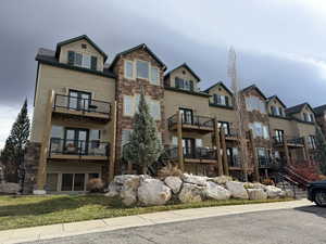 View of front facade featuring stone siding